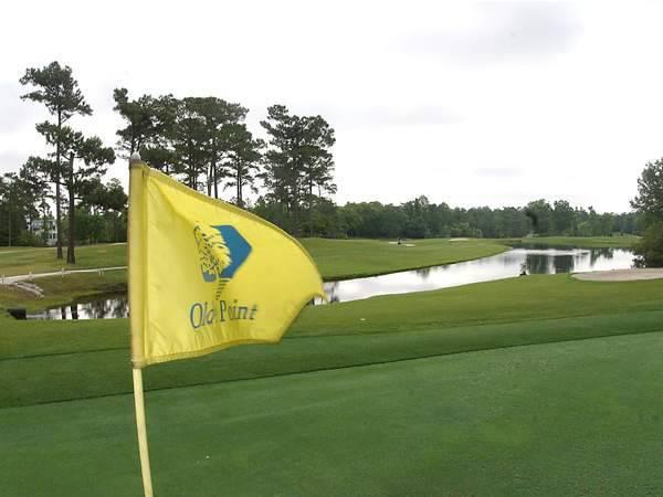 Yellow flag with course logo on golf course